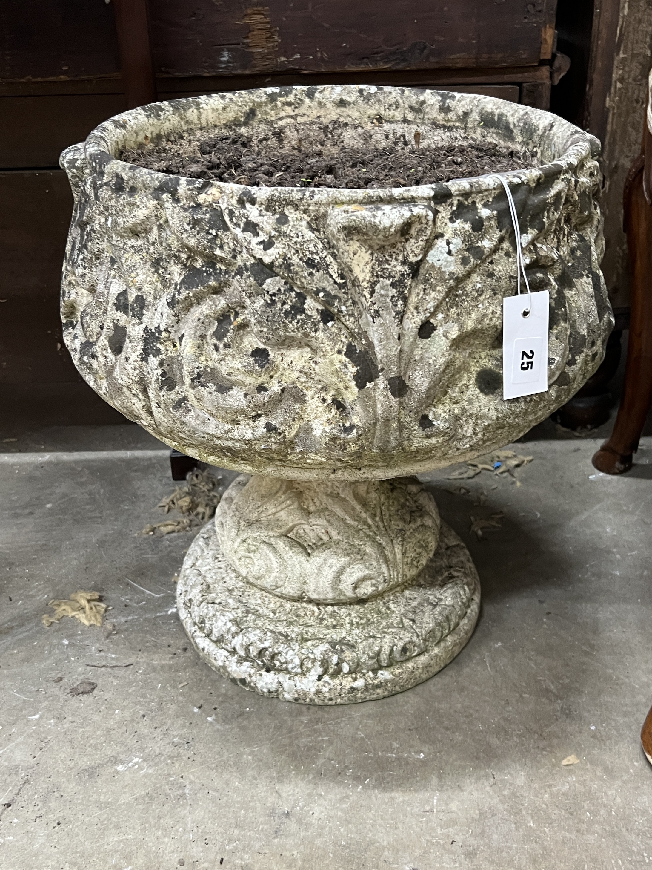 A circular reconstituted stone garden planter, diameter 42cm, height 46cm